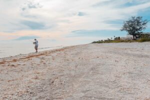 sanibel visitor fishing at island inn hotel beach